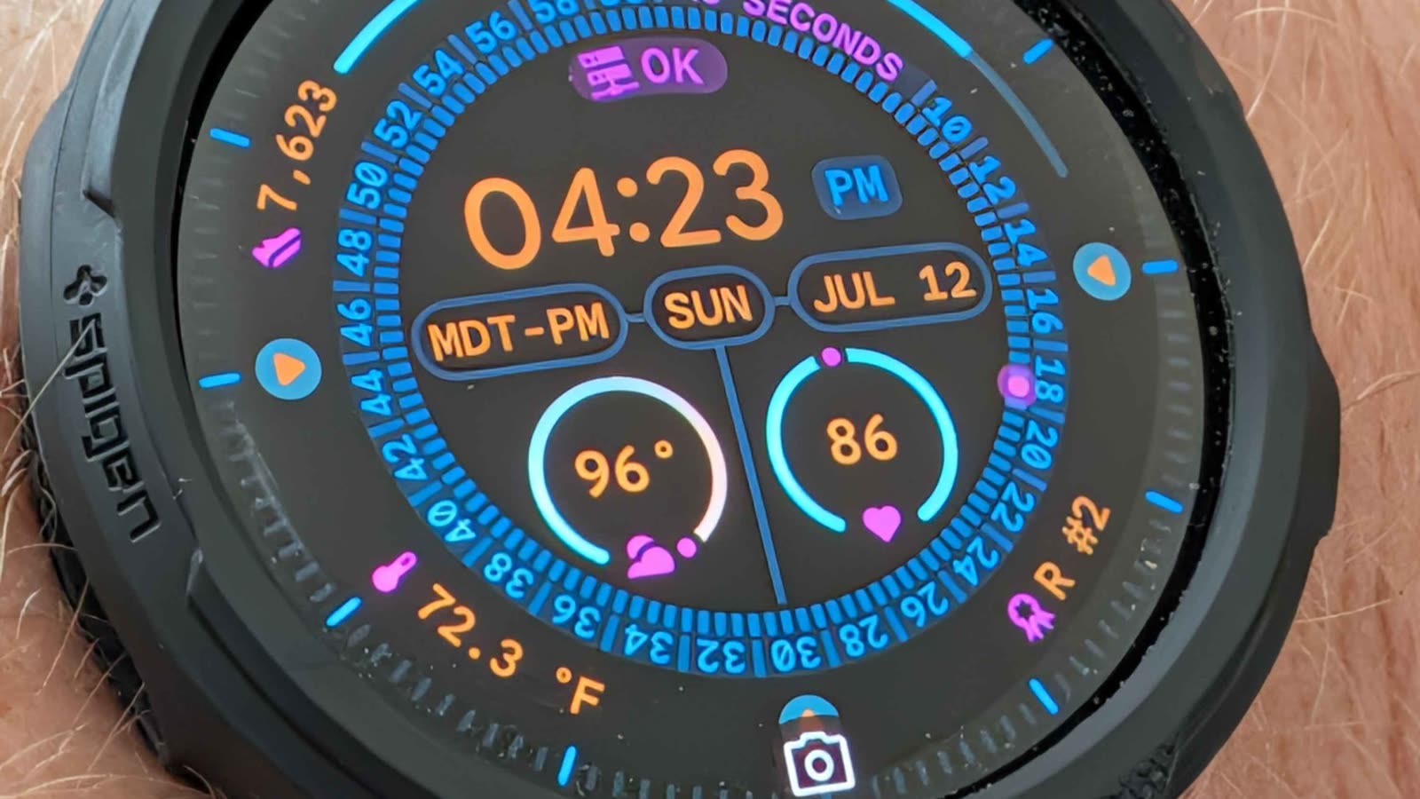 Close-up of a Pixel Watch showing a purple homelab status complication reading OK.
